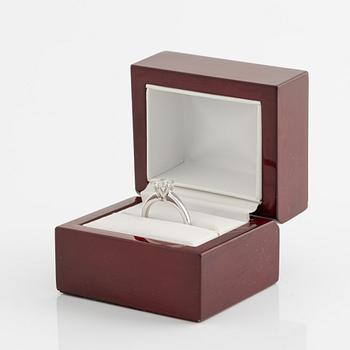 An 18K white gold ring set with a round brilliant-cut diamond.