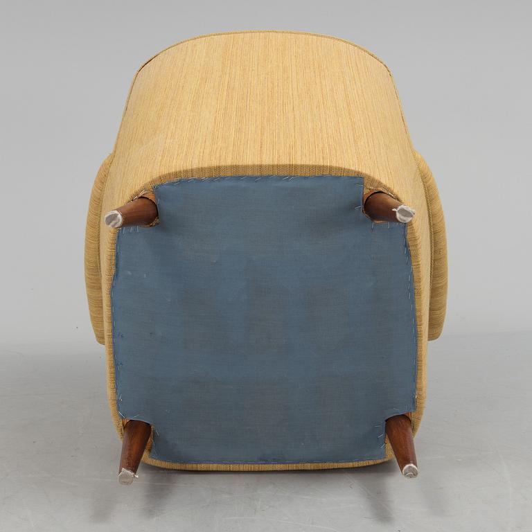 A mid 20th century armchair "Hemmakväll" designed by Carl Malmsten .