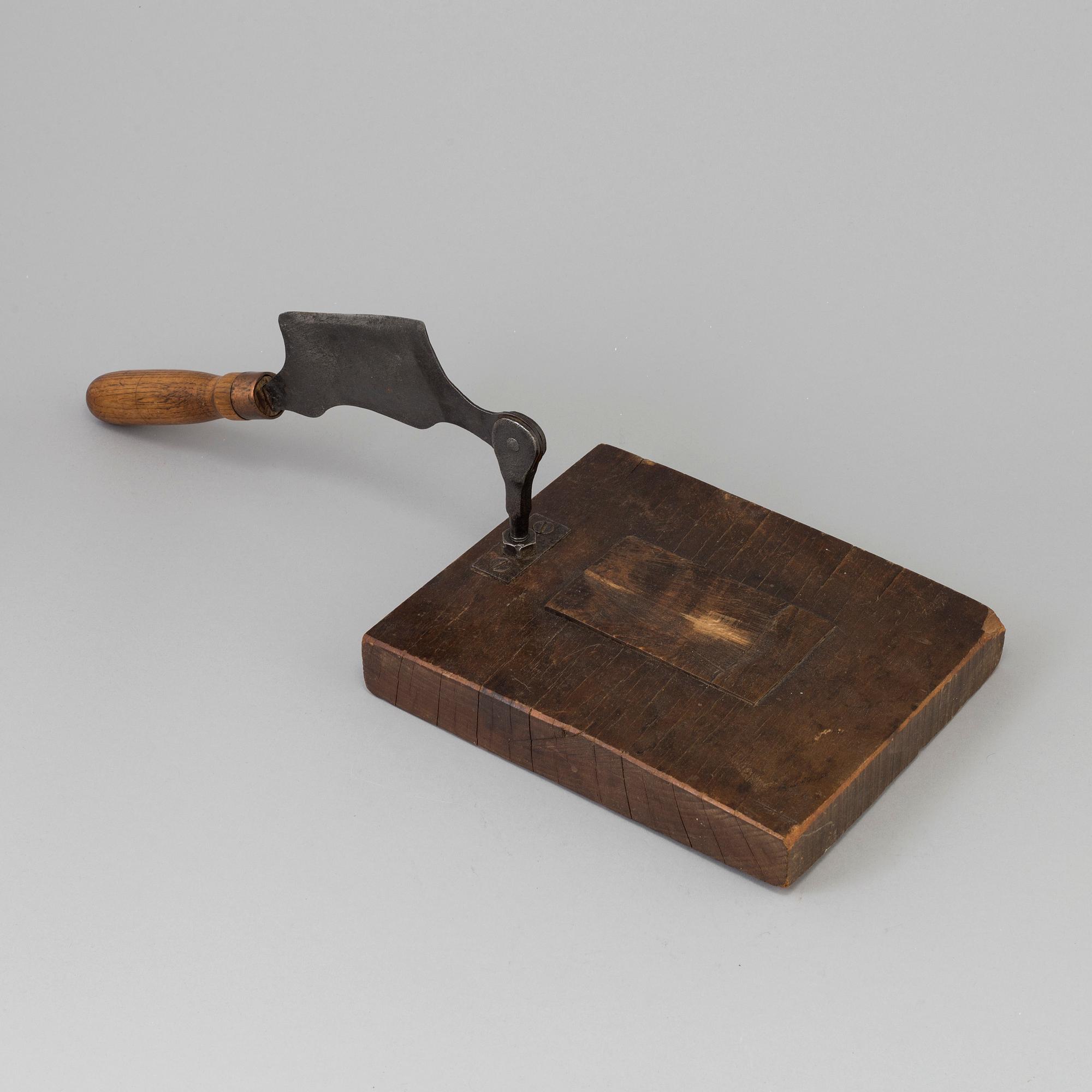 A 19TH CENTURY TOBACCO CUTTER, wood and iron.