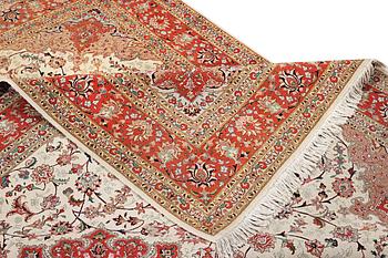 A Tabriz carpet, part silk, 50 raj, c. 304 x 204 cm.