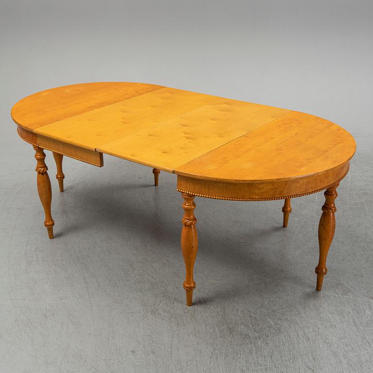 A mid 19th century birch dining table.