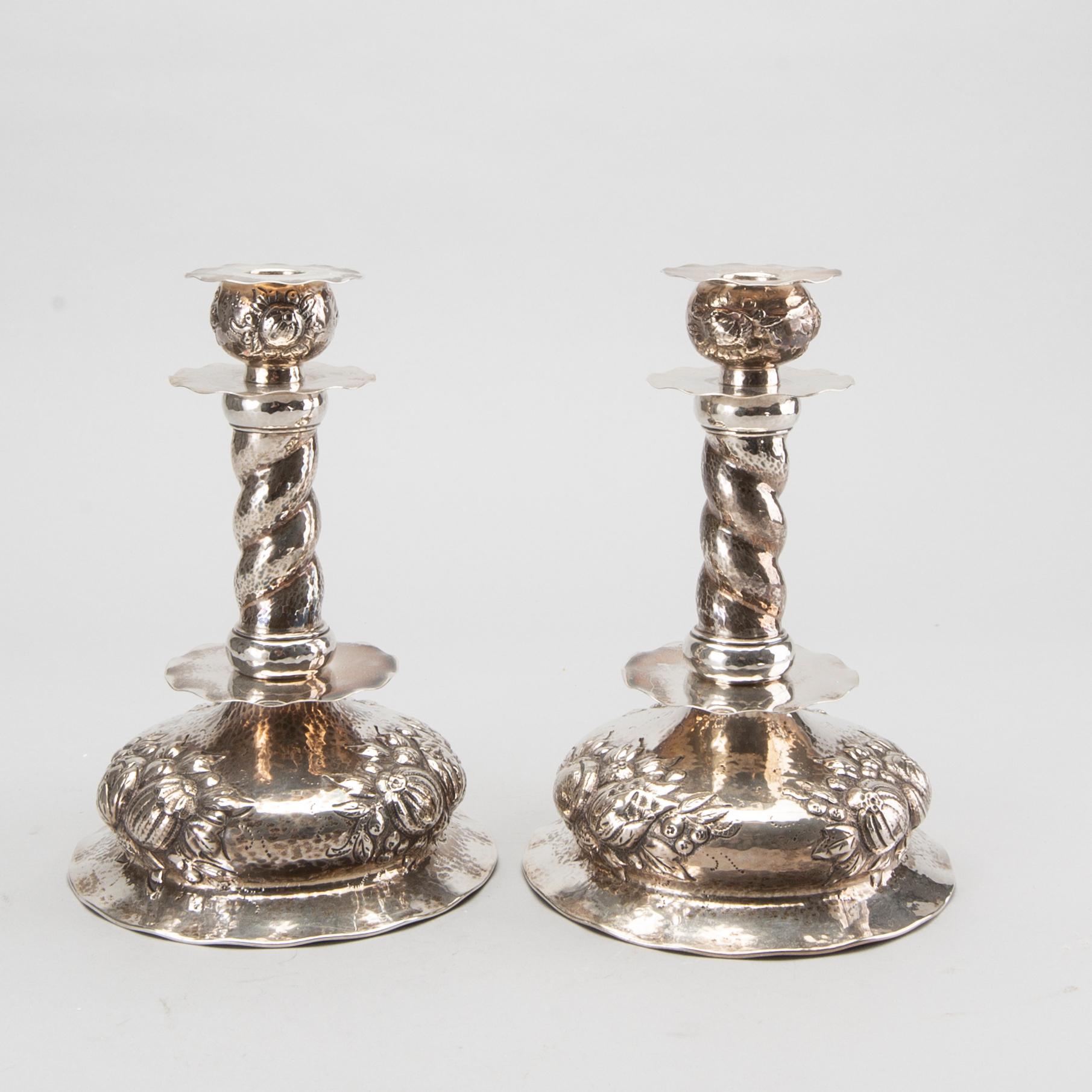 A pair of silver baroquestyle candlesticks. W.H.H, Stockholm. 1935. Filled foot.