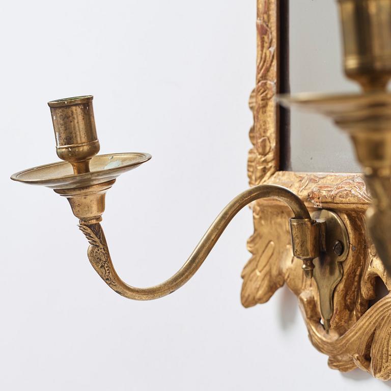 A pair of Rococo 18th century two-light girandole mirrors.