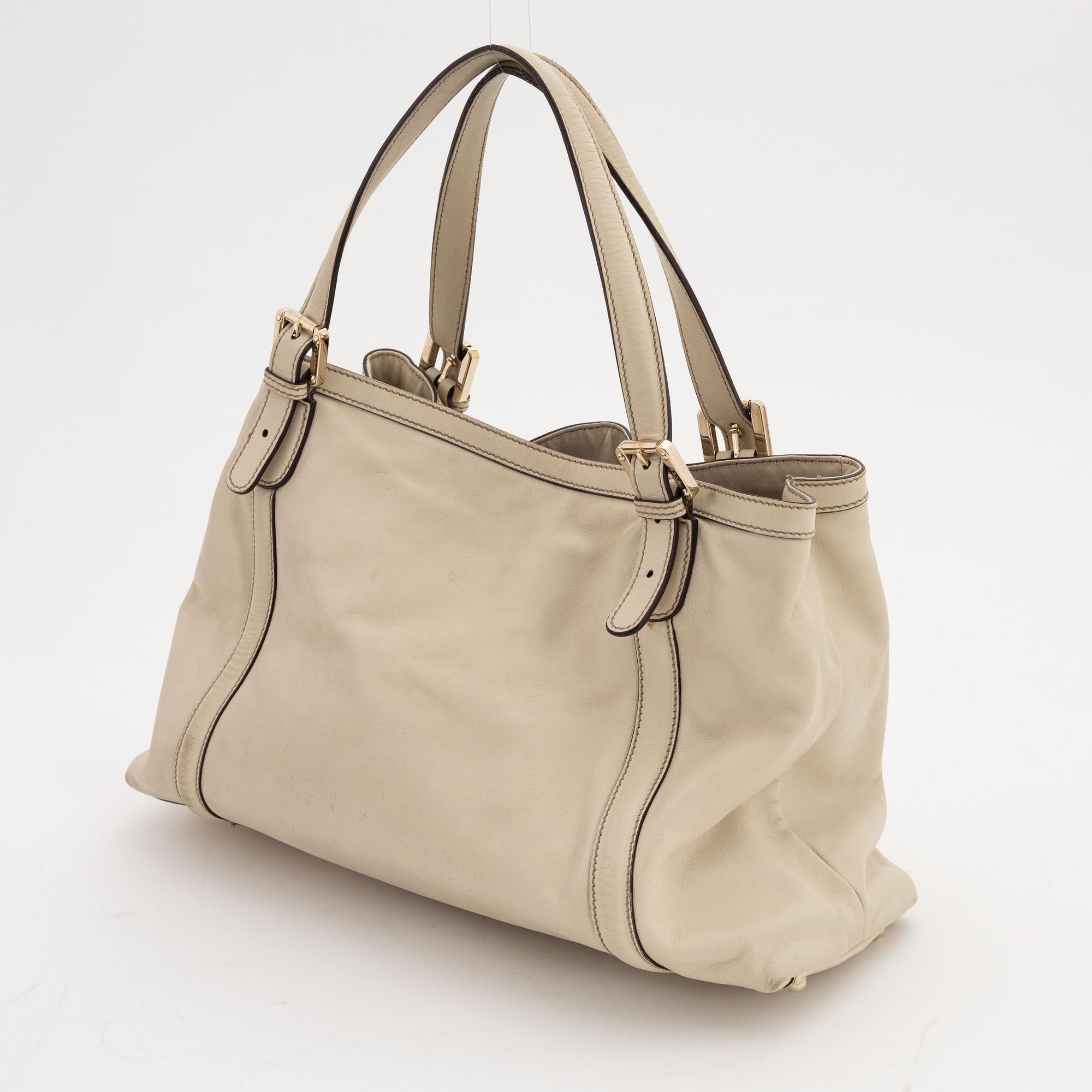 Gucci, a cream leather handbag.