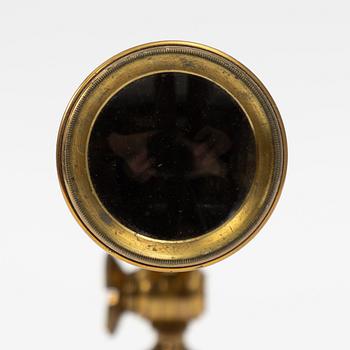 A telescope on a tripod, 19th/20th century.