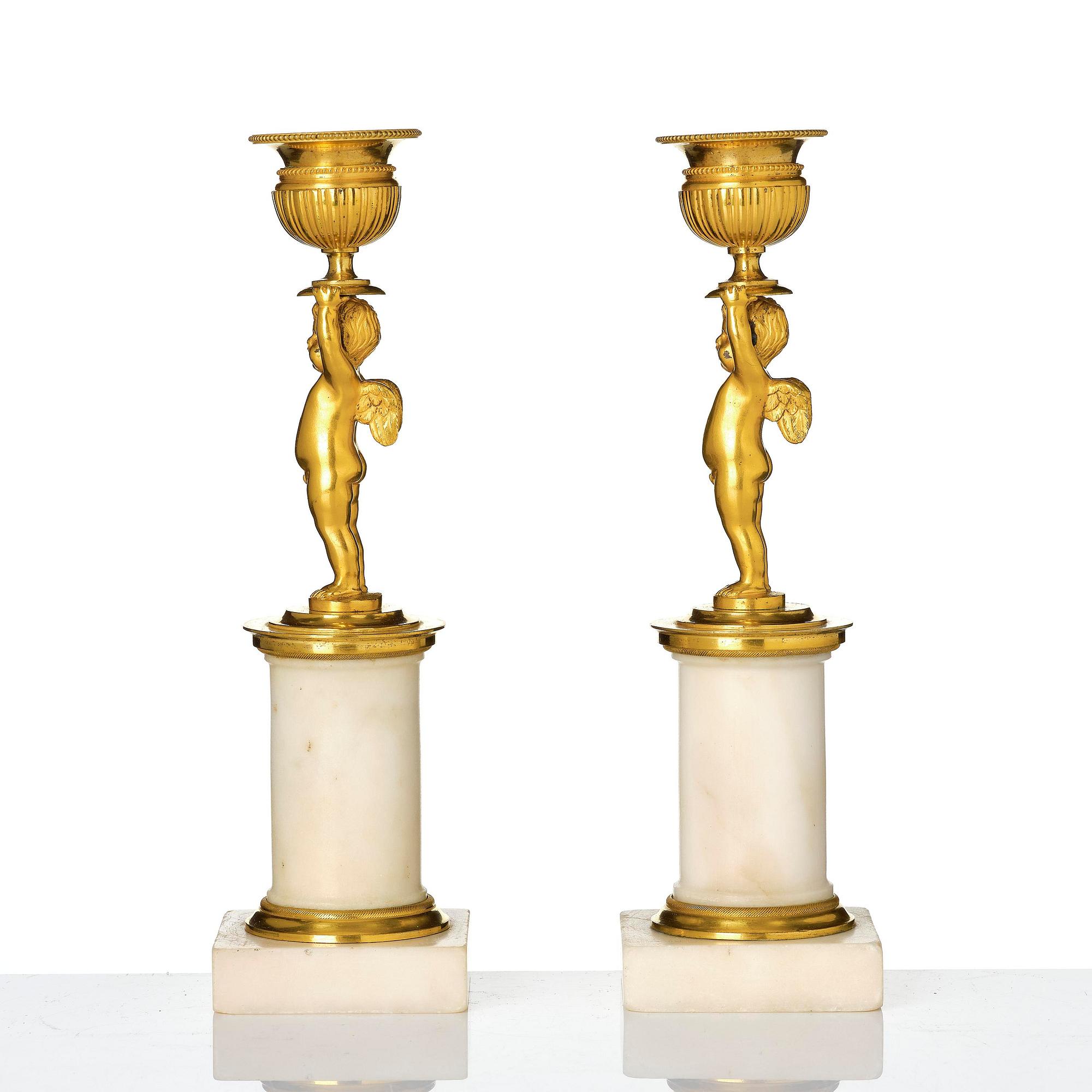A pair of late Gustavian white marble and ormula candlesticks.