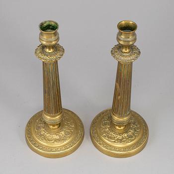 A pair of empire bronze candlesticks, first half of the 19th century.