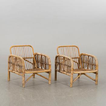 A pair of the second half of the 20th century ratten and bamboo lounge chairs.