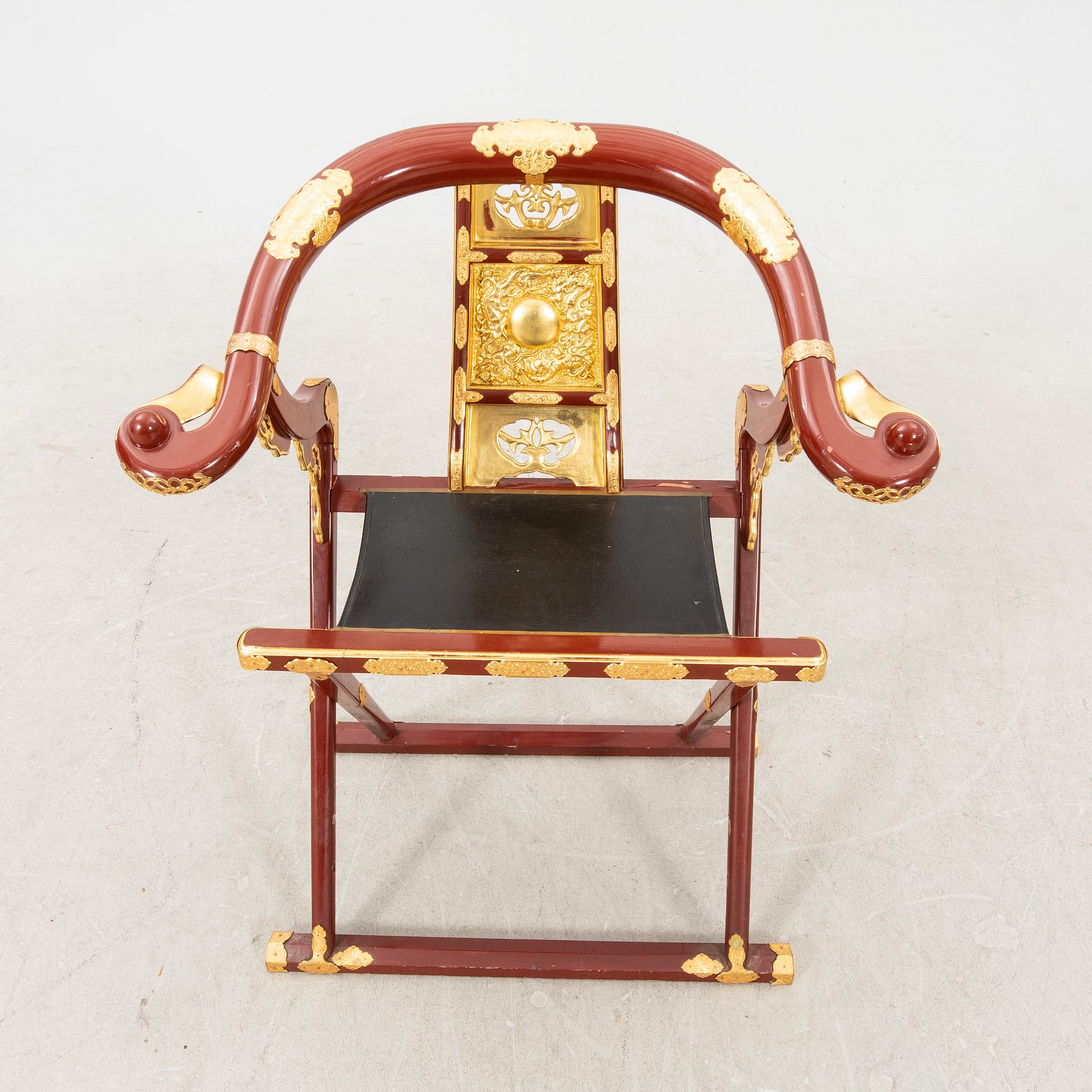 A laqcuered wooden chair from China 21st century.