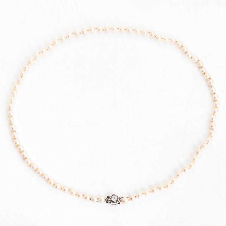 A cultured pearl necklace, clasp with white zircons.