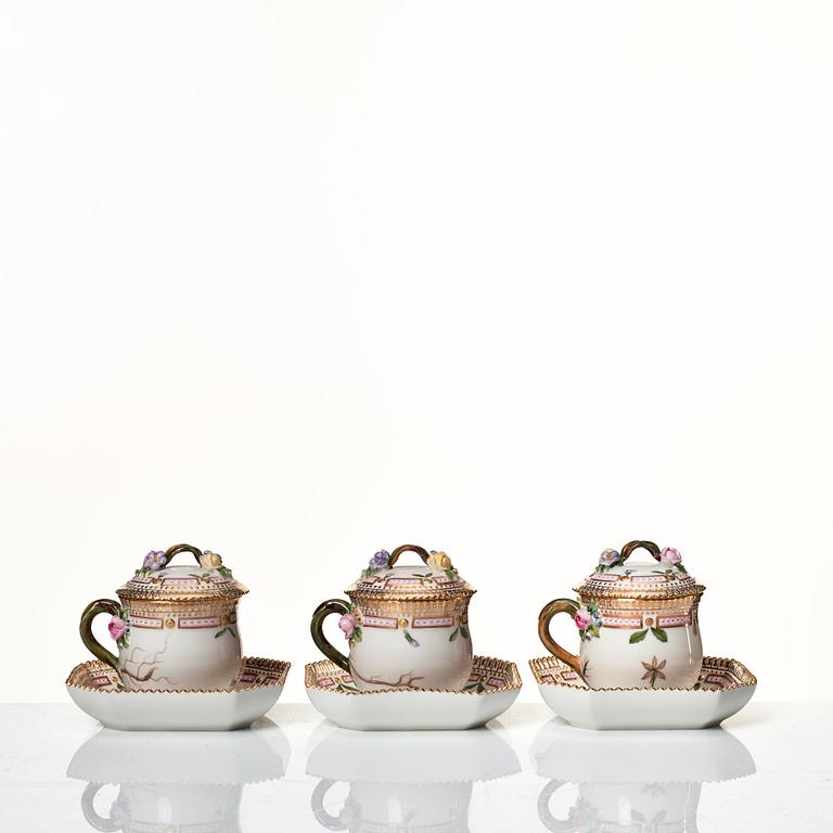 A set of 12 Royal Copenhagen 'Flora Danica' custard cups with covers and stands, Denmark, 20th Century.