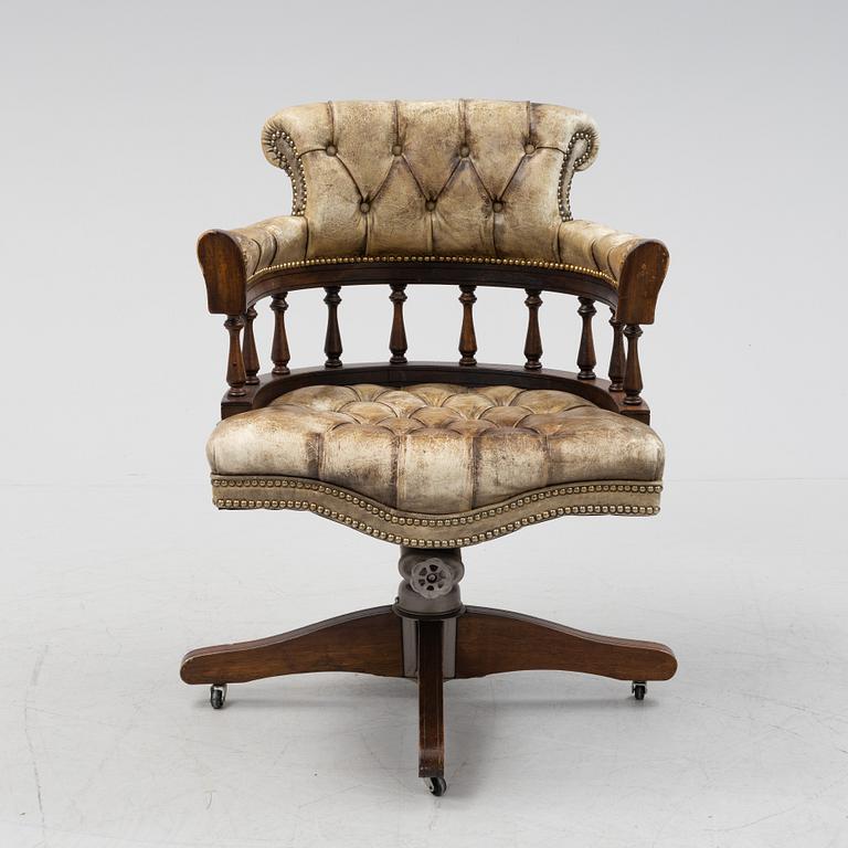 A 20th Century English mahogany and leather desk chair by Hillcrest Chair Actions.