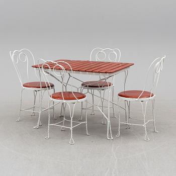 A garden table and four chairs, first half 20th century.