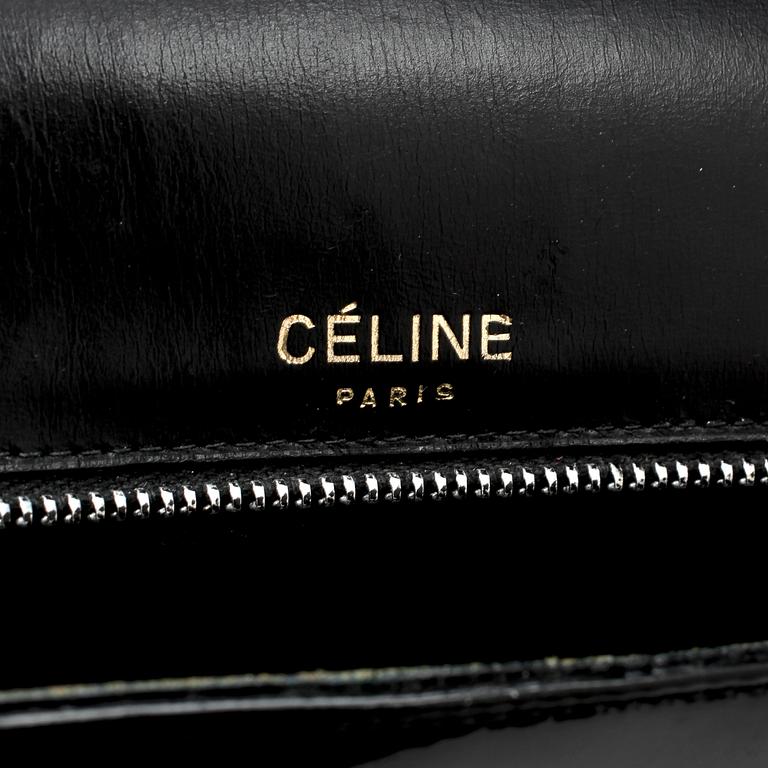 CÉLINE, a black leather patent shoulder bag.