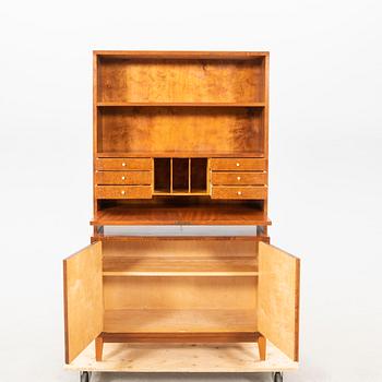 A 1940s mahogany book shelf with writing desk.