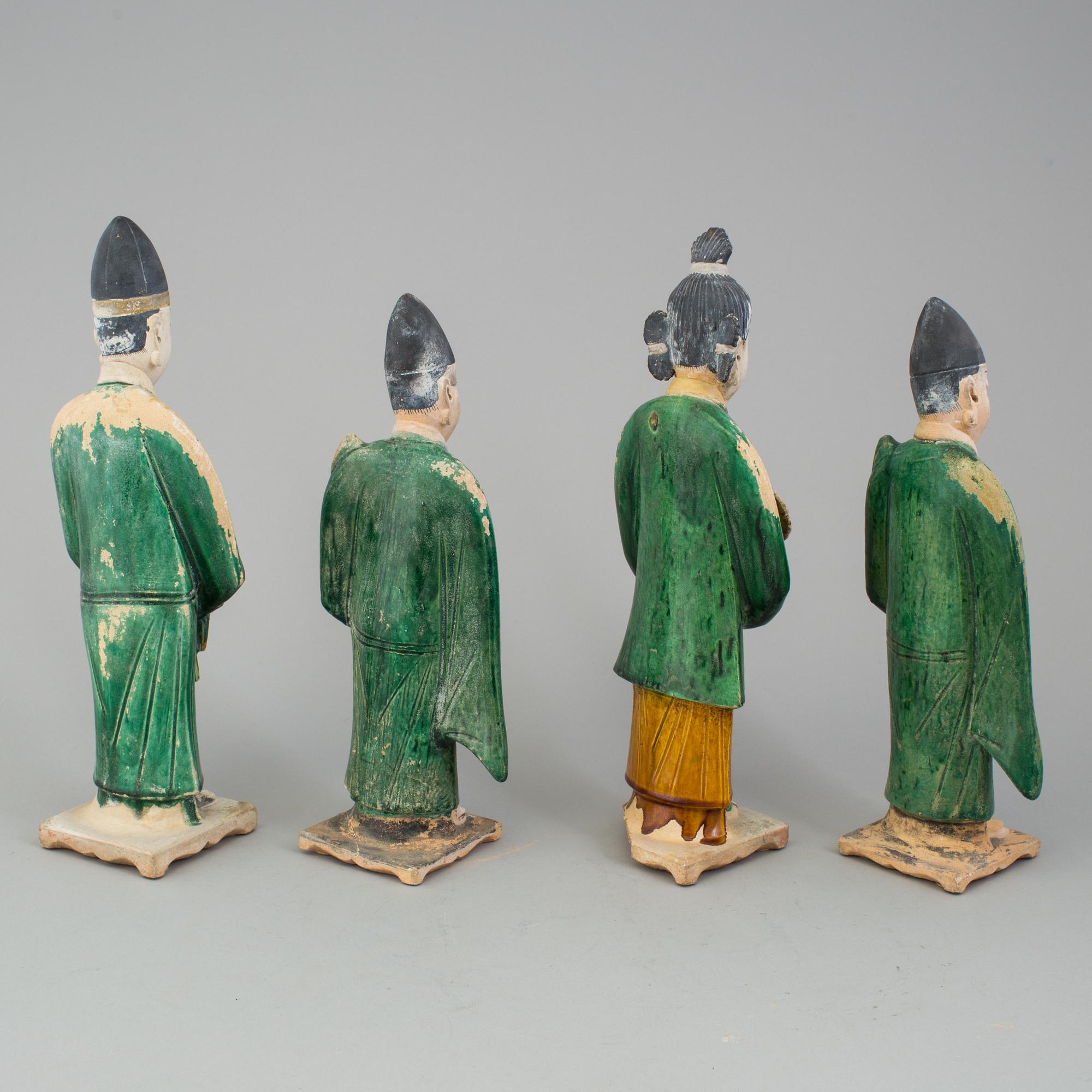 A group of eight chinese figures with three objects, earthenware, Ming dynasty.