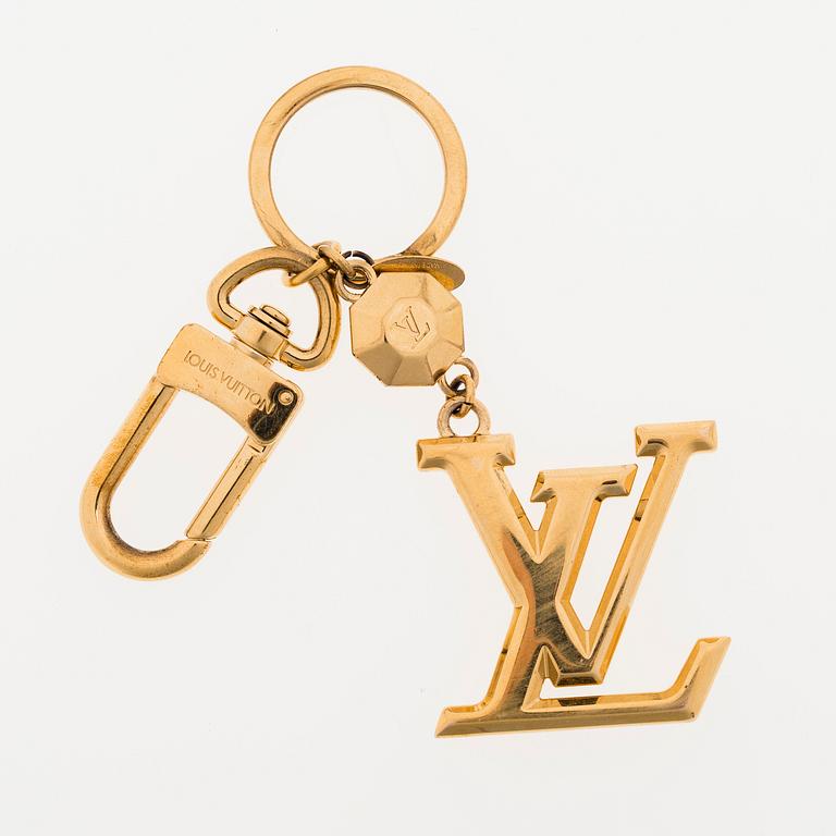 A Louis Vuitton bag charm.