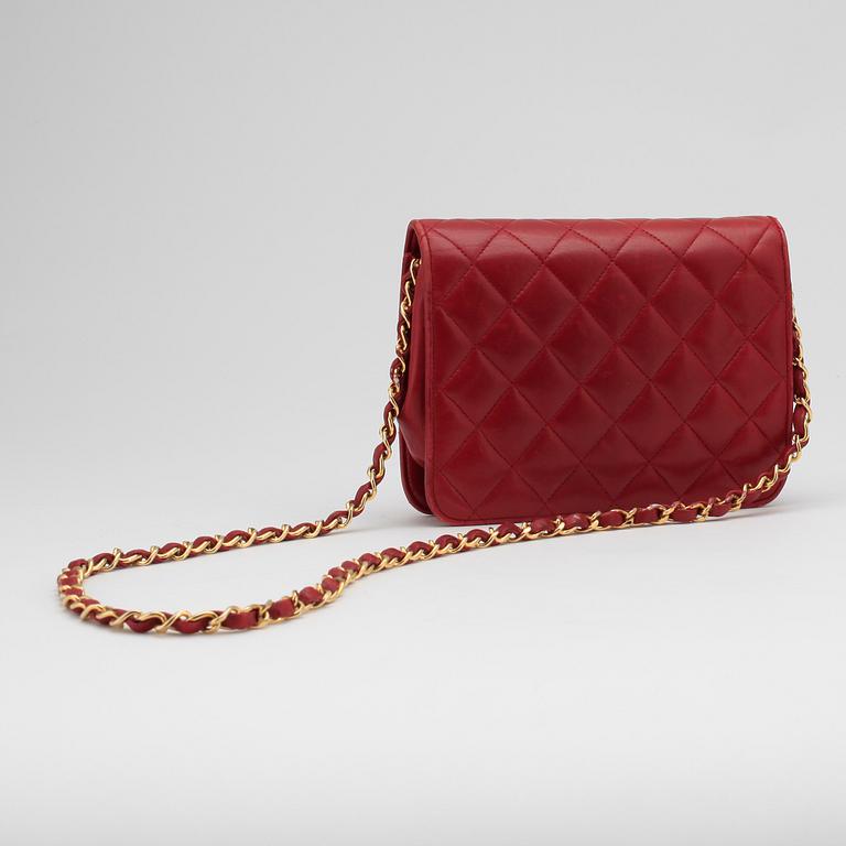 CHANEL, a red leather shoulder bag.