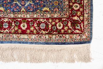 An Oriental silk rug, signed, c. 125 x 85 cm.