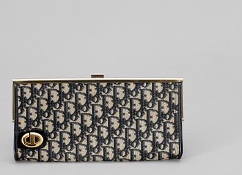 A blue monogram canvas clutch by Christian Dior.