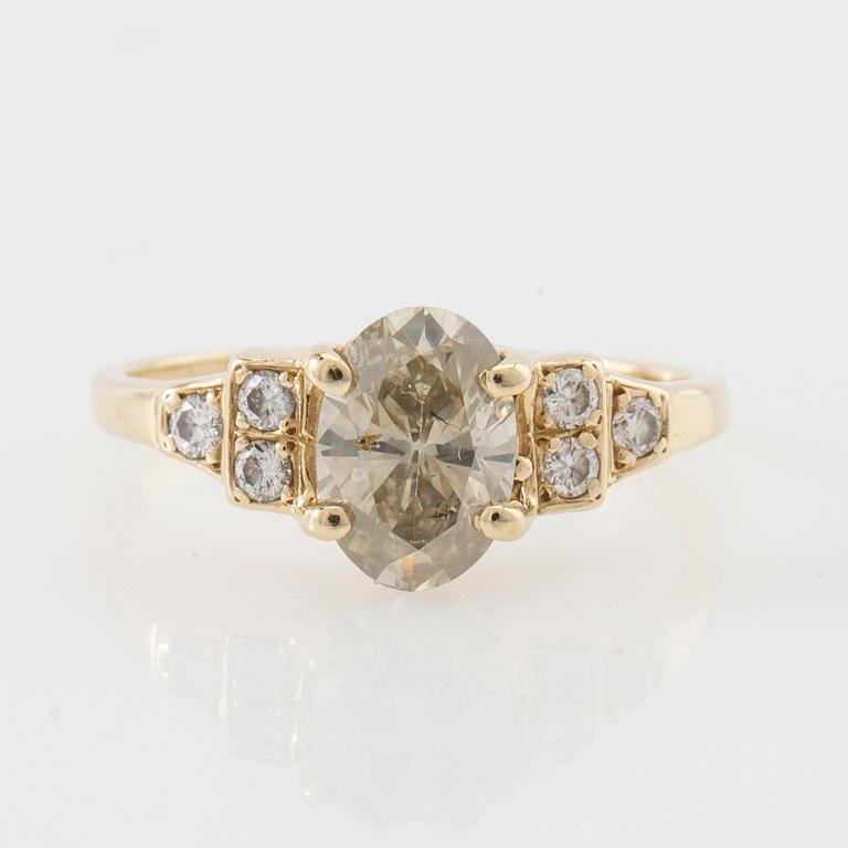 Ring 14K gold with an oval faceted diamond approximately 1.23 ct and round brilliant-cut diamonds.