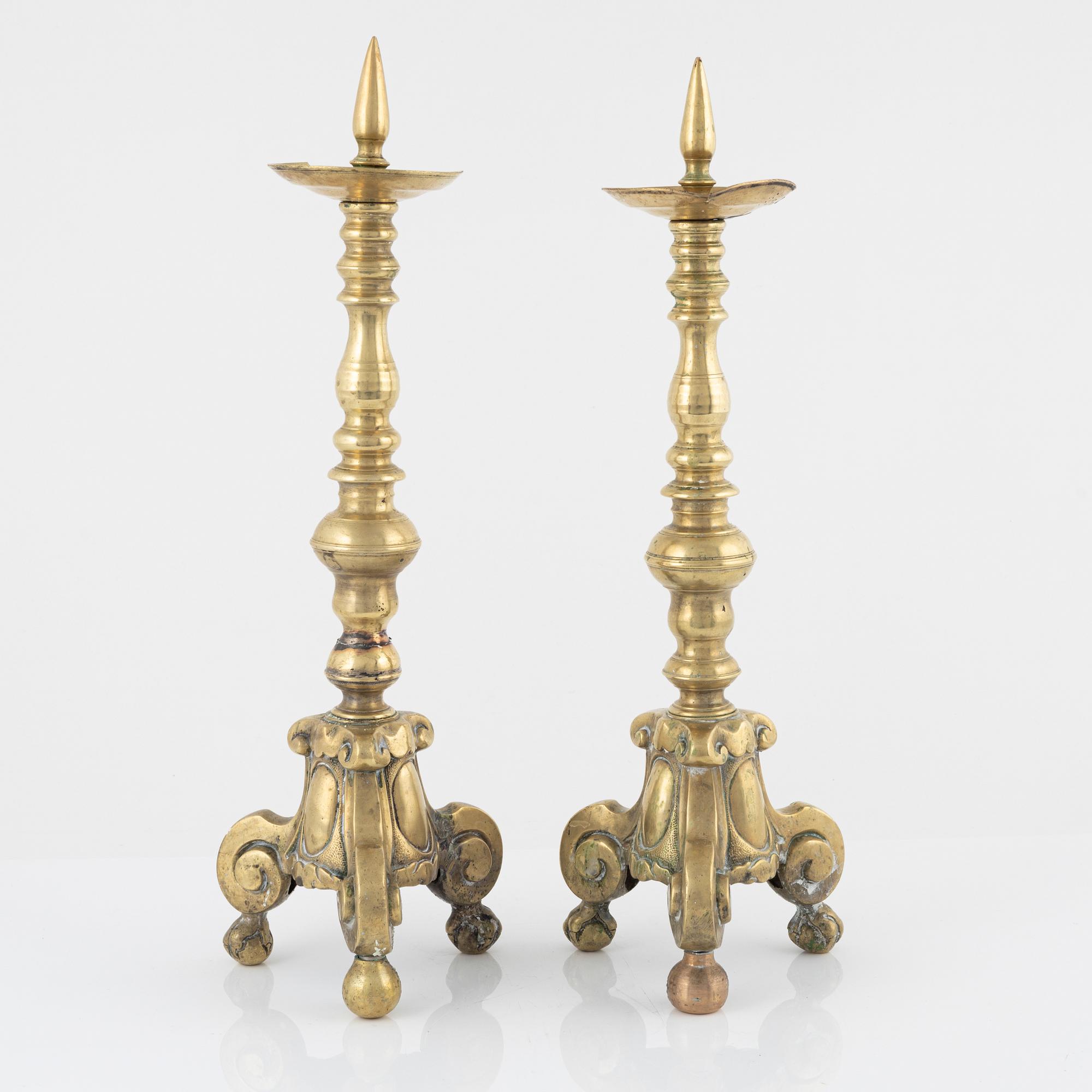 A pair of brass candle sticks, around 1700.