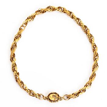 An 18K gold choker necklace, with an oval faceted citrine.