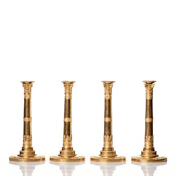 A set of four Empire presumably Russian candlesticks in gilded bronze.