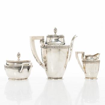 A silver coffee pot, creamer and sugar bowl, import marks of Axel Larson, Helsingborg 1920.