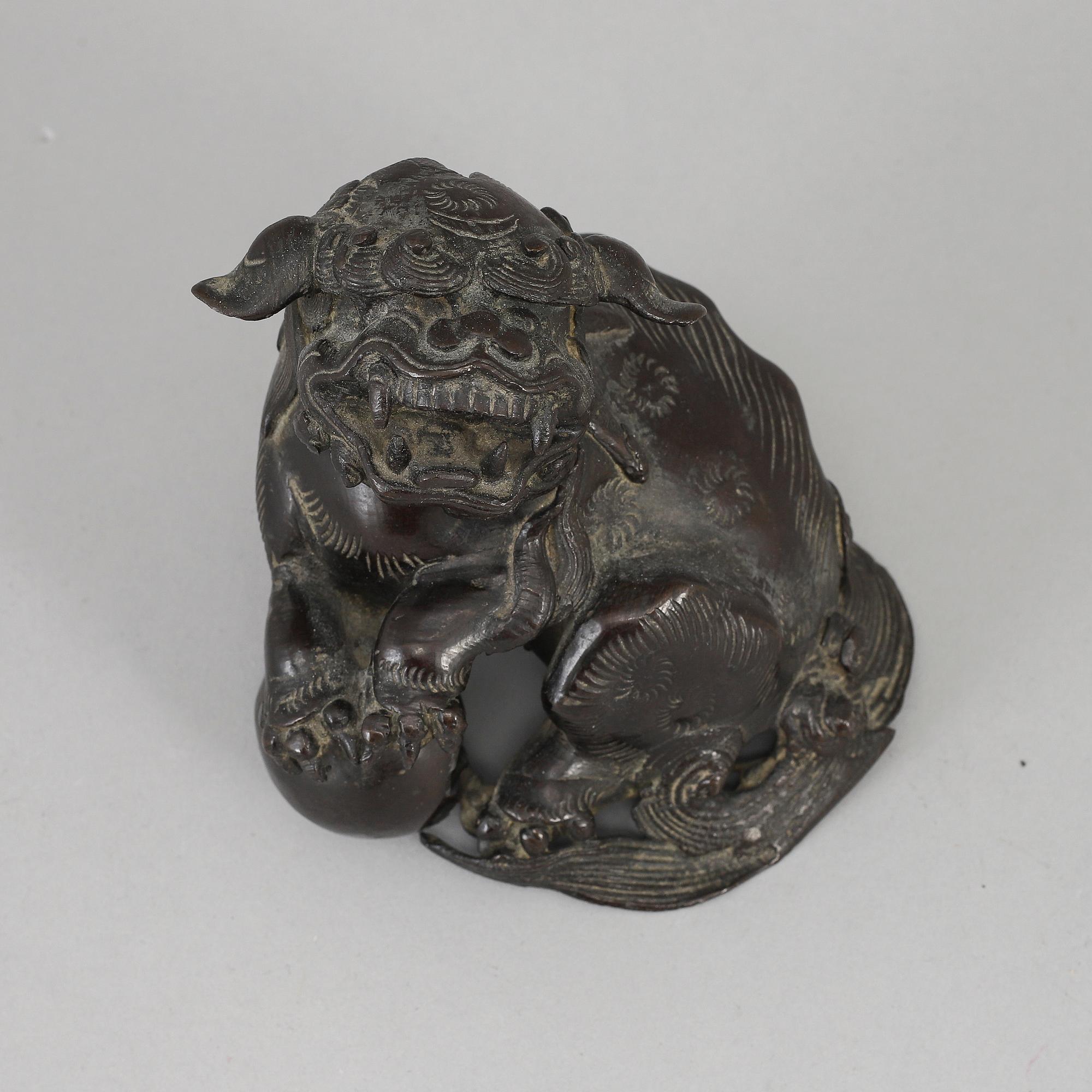 A bronze figure of a buddhist lion, Qing dynasty, circa 1900.