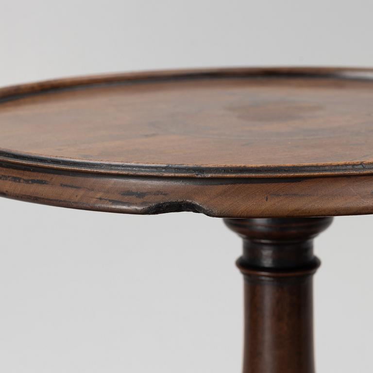 A mahogany three-tier table, England, circa 1900.
