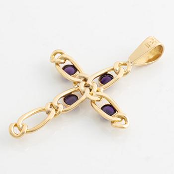 A cross in 18K gold with cabochon-cut amethysts and a white stone.