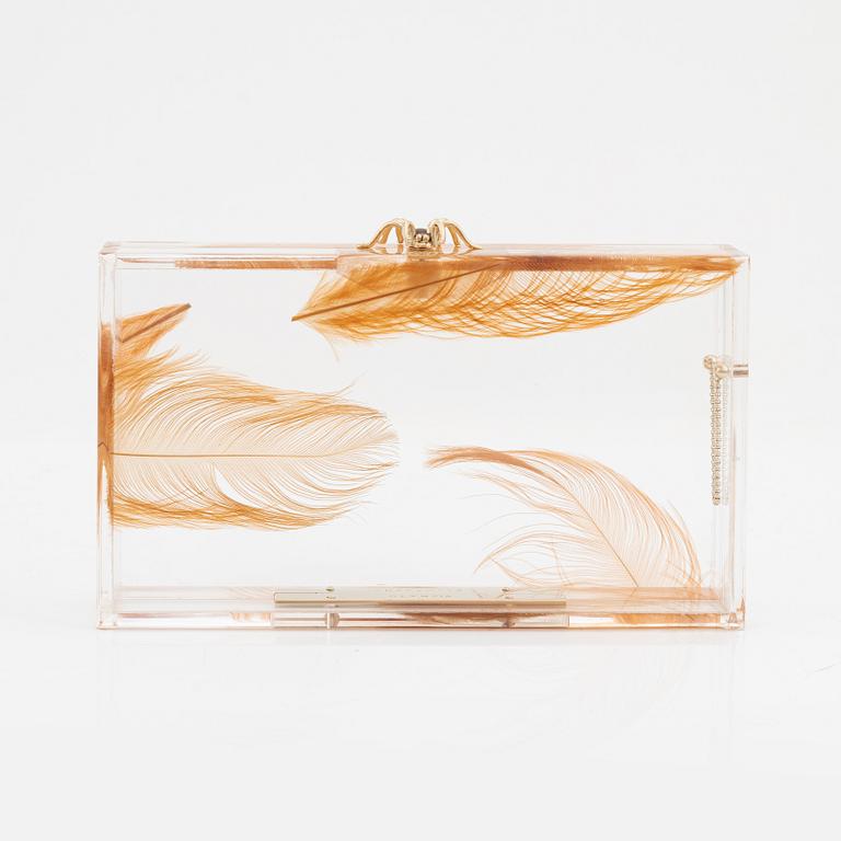 Charlotte Olympia, a transparent clutch with feathers and a spider.