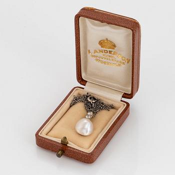 A platinum and pearl pendant set with old-cut diamonds.