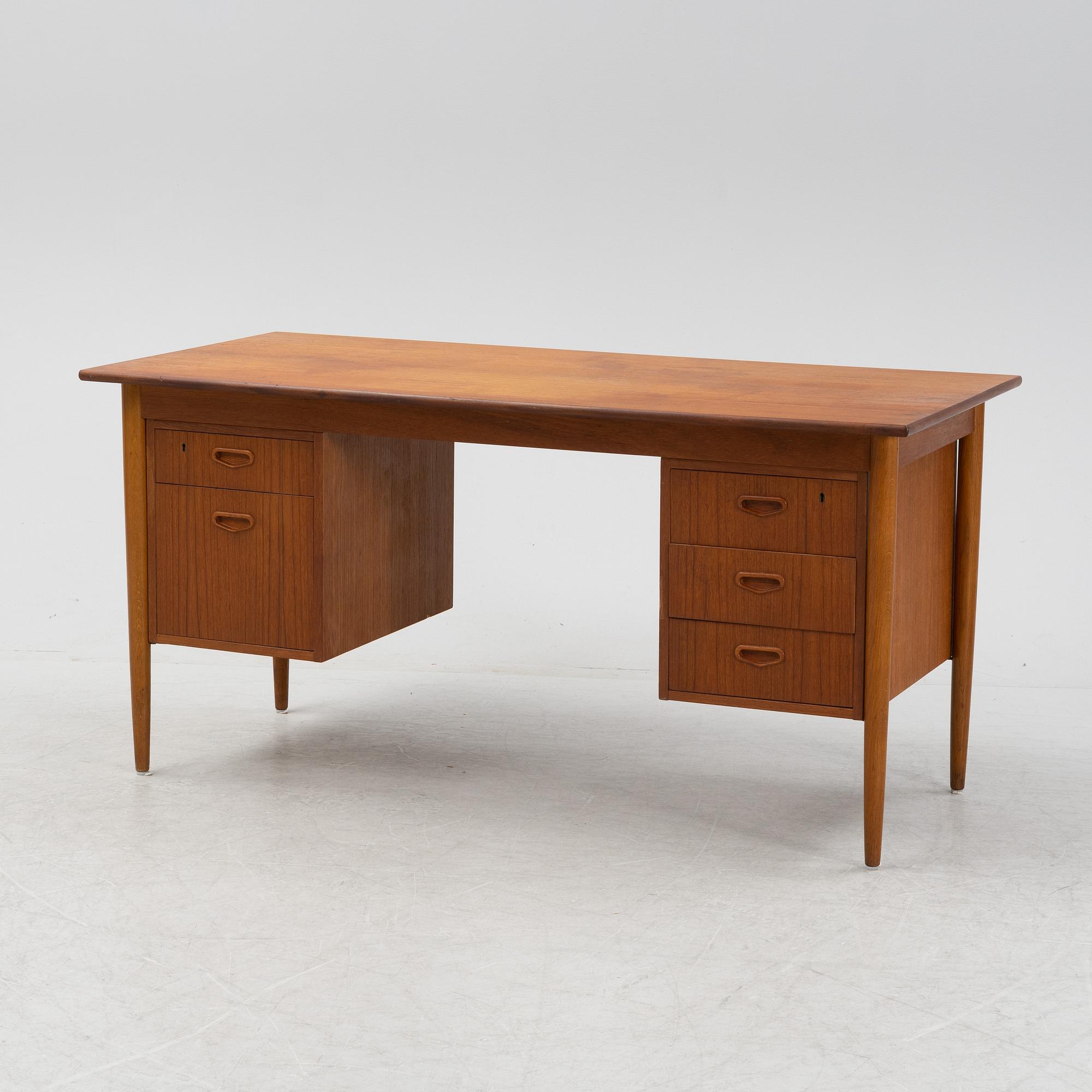 A teak veneered desk, 1950's/1960's.