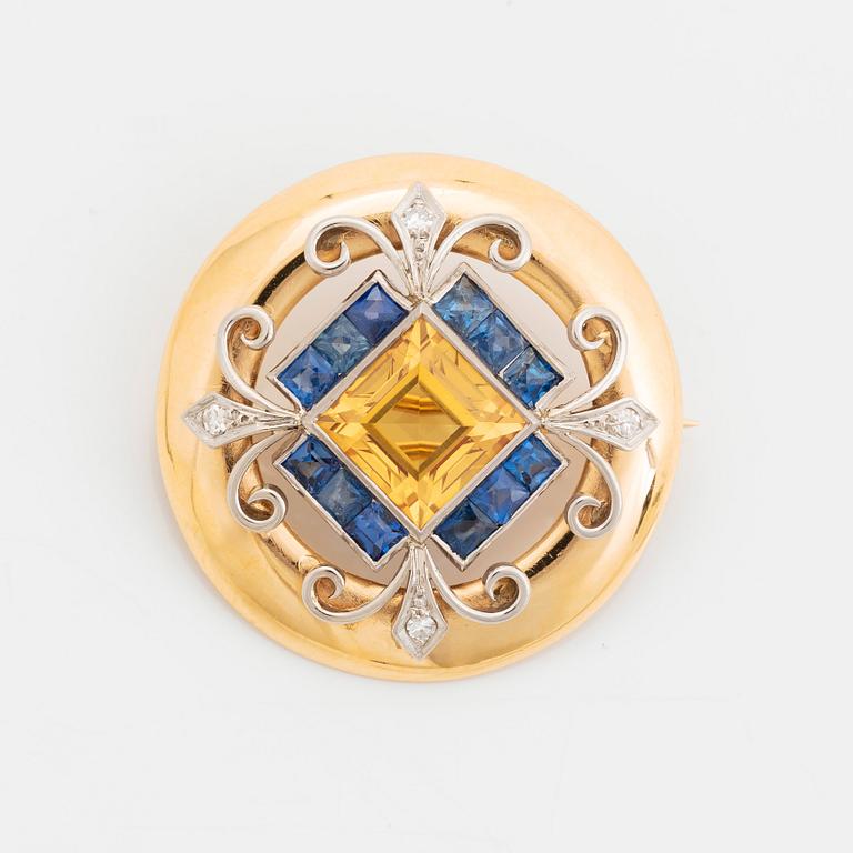 An 18K gold brooch set with a step-cut yellow sapphire possibly synthetic.