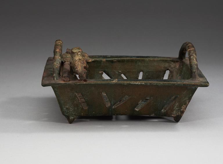 A green glazed vessel, Han dynasty (206 BC – 220 AD).