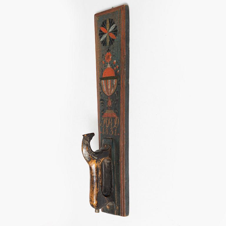A painted wooden mangle board, dated 1831.