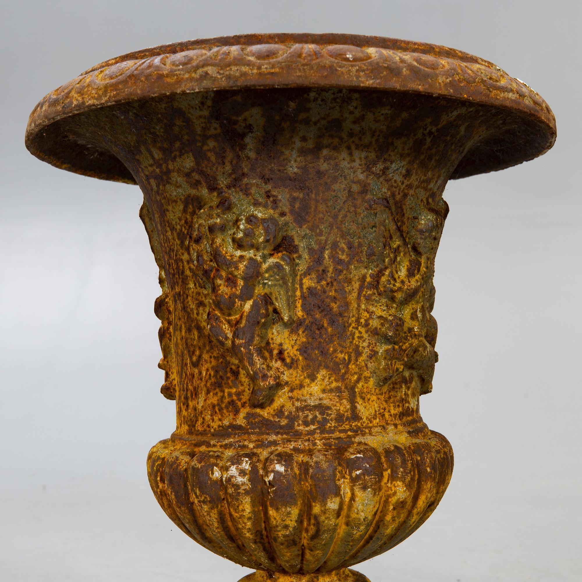 A pair of cast iron garden urns fist half of the 20th century.