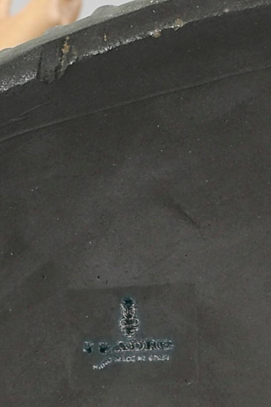 A Lladro stone ware figurine.