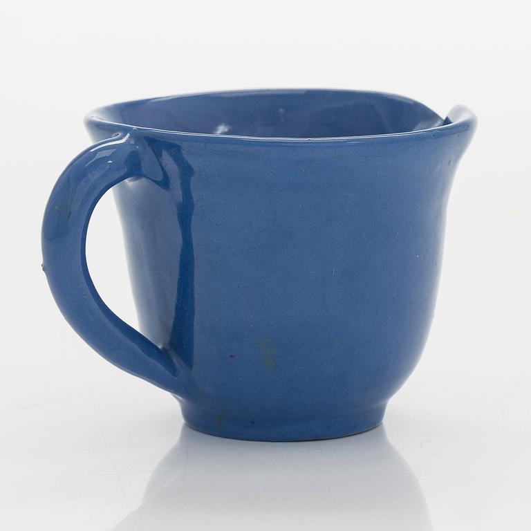 Marita Lybeck, a set of three ceramic plates and cream jug, red clay, signed ML.