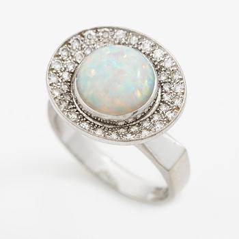 A ring 18K white gold set with an opal and eight-cut diamonds. CF Carlman, Stockholm 1973.