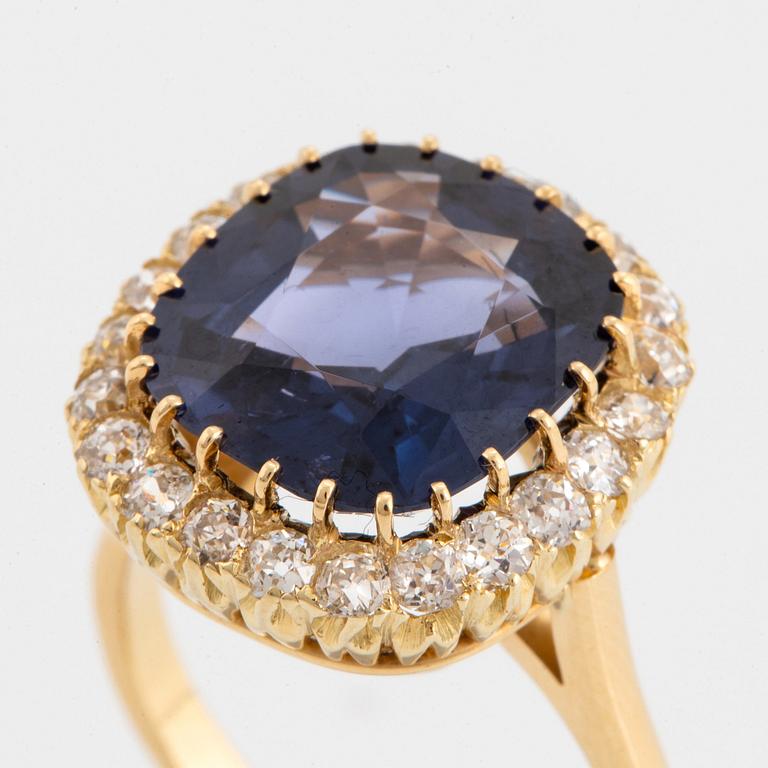 An 18K gold ring set with a cushion-cut purple spinel 6.15 cts according to information given.