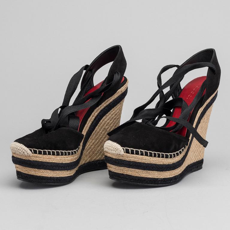 A pair of Gucci wedge shoes size 36.