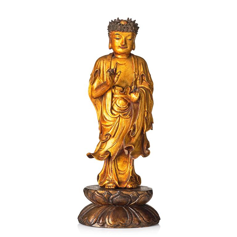 A lacquer figure of a standing Buddha, late Ming dynasty/early Qing dynasty.