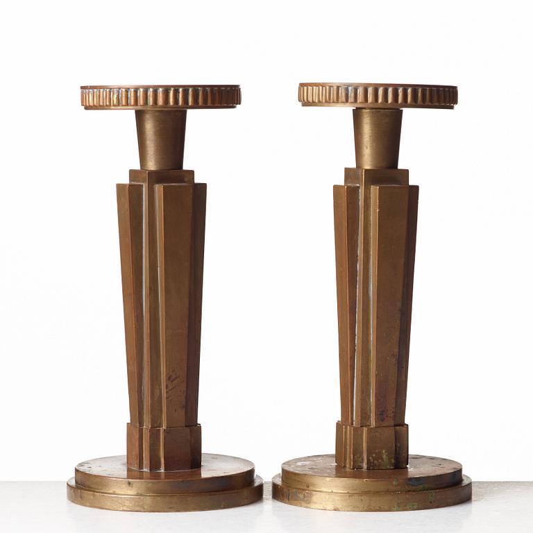 Lars Holmström, a pair of Swedish Grace patinated bronze candlesticks, Arvika, Sweden, 1920's-30's.