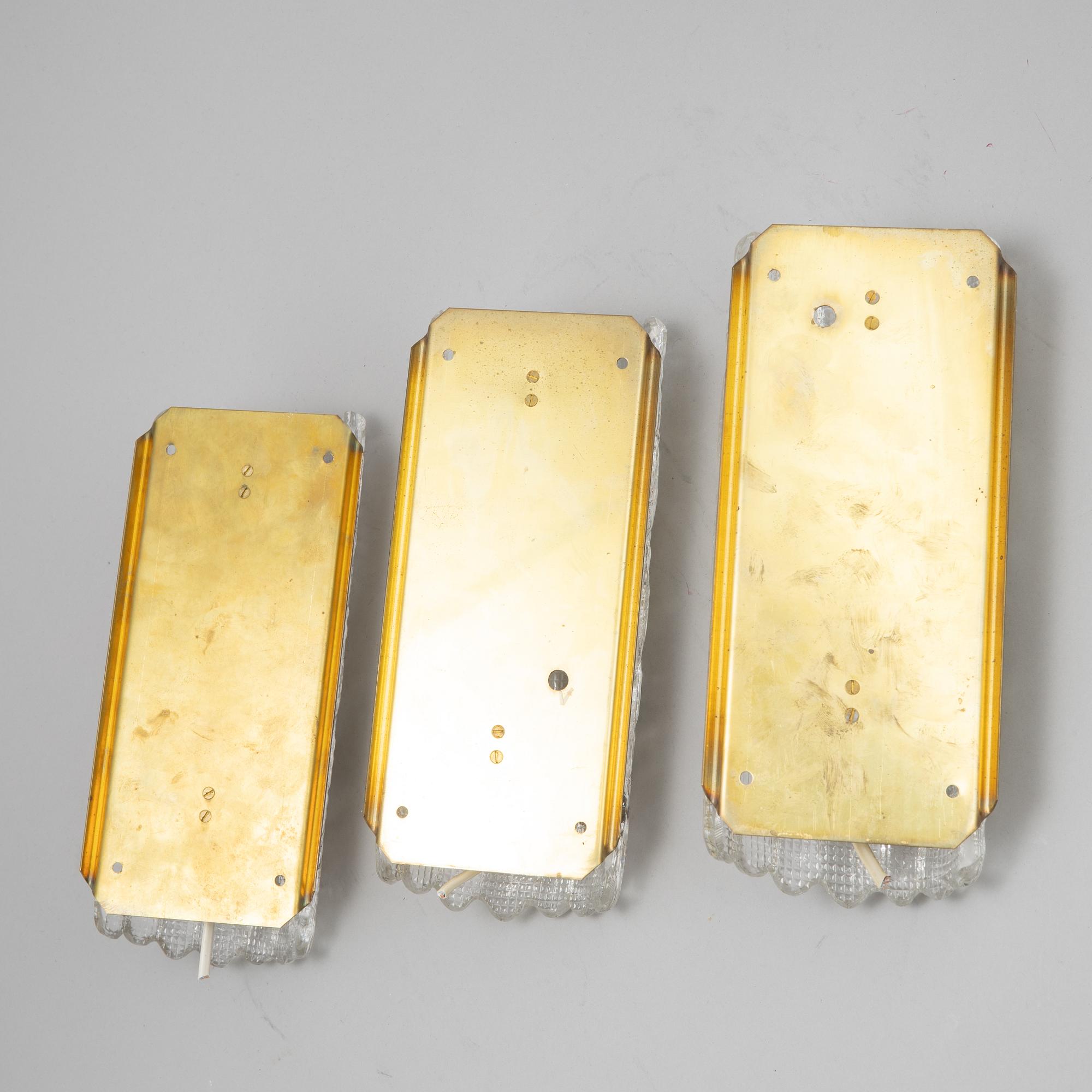 Carl Fagerlund, a set of three glass and brass wall lights, Orrefors/Nya ÖIA, second half of the 20th Century.