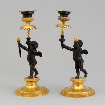 A pair of late 19th century, gilded bronze, Empire style, candle sticks.