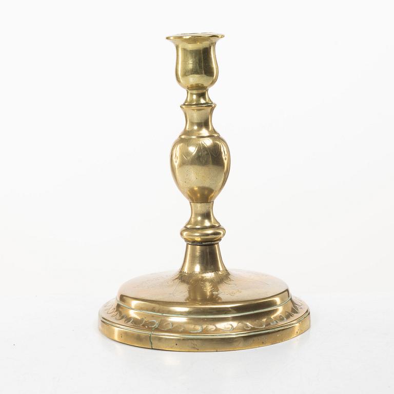 A candle holder in brass, Baroque, 17th/18th century.