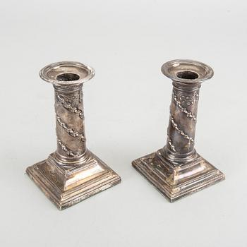 HAWKSWORTH, EYRE & CO LTD a pair of silver candlesticks.